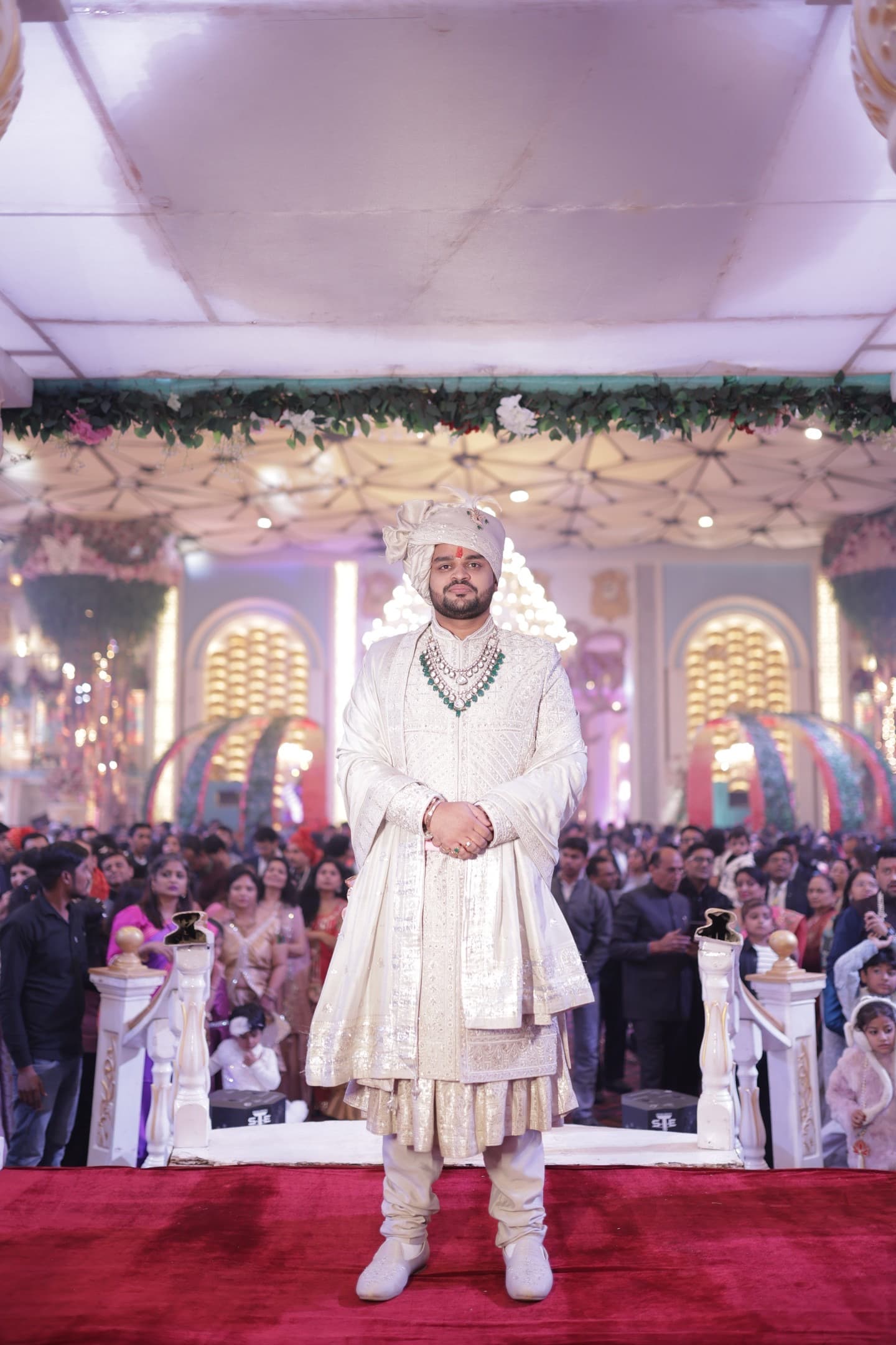 Arjun standing at the mandap entrance at Rajdevam